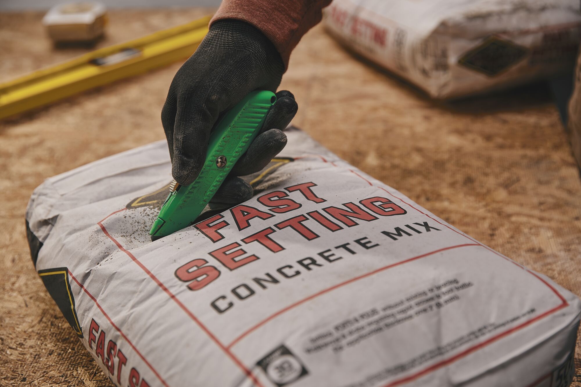 5 and 7 eighths inch High visibility retractable utility knife opening concrete packet.