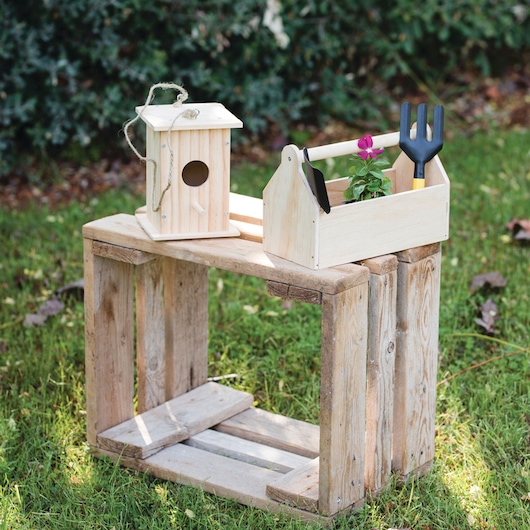 Assembled Stanley junior wooden DIY kit birdhouse placed on grass outdoors.